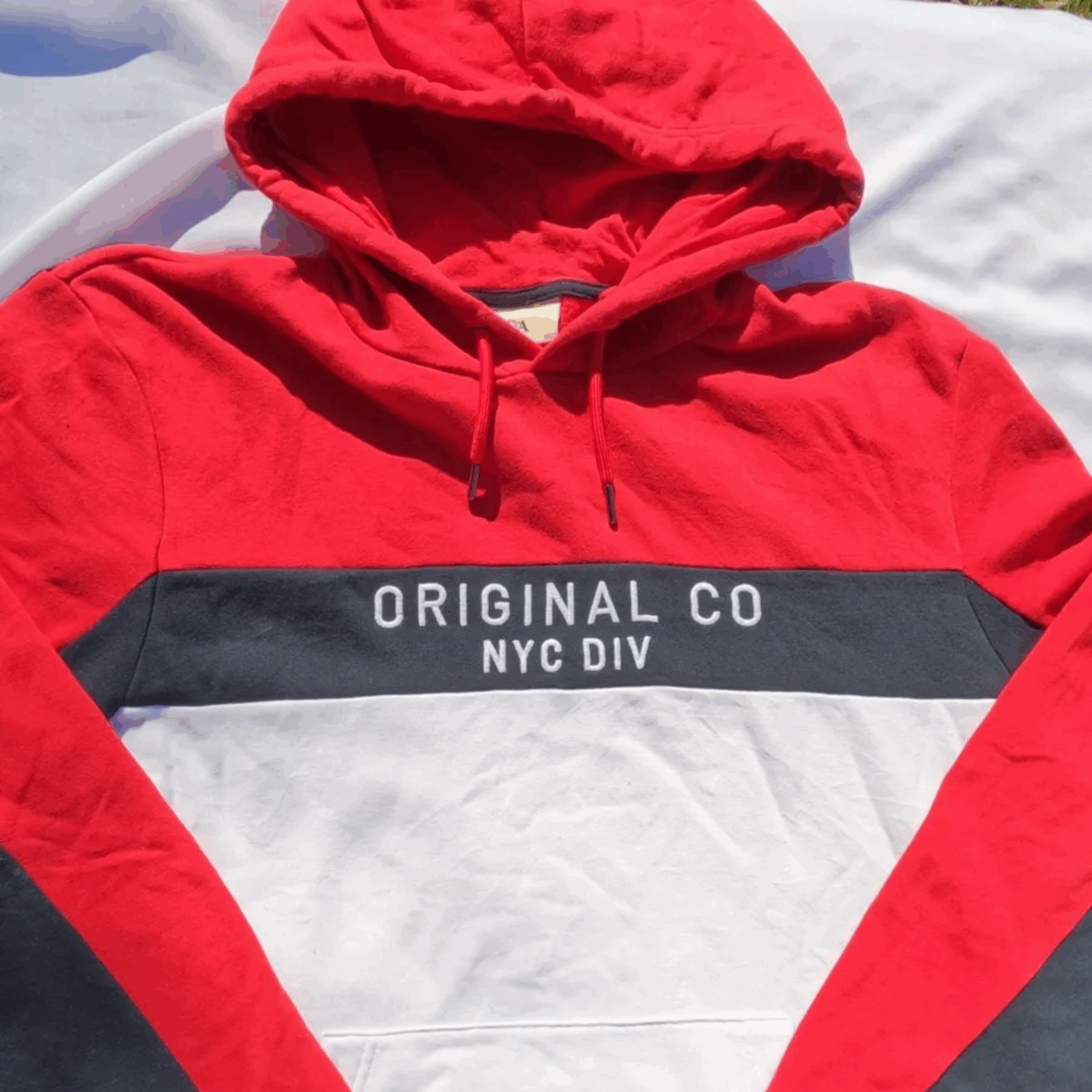 : Red, white, and grey color-block C&A hoodie with NYC text graphic, size XL.
