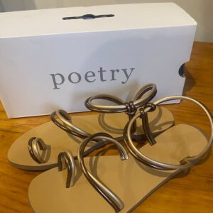 Women’s sandals in front of shoebox.
