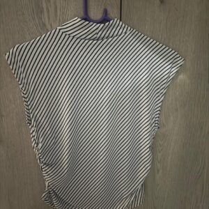 Back view of sleeveless black and white diagonal stripe top